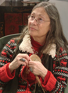 Artist Judy DeRosa working on a pine needle basket start.